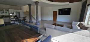 a living room with couches and a tv and a kitchen at Casa Velero in Puerto Vallarta