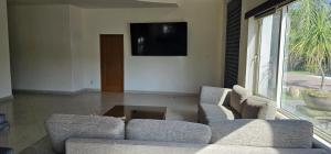 a living room with two couches and a tv at Casa Velero in Puerto Vallarta