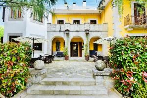 a courtyard of a building with chairs and umbrellas at Hotel Punta Me Torreblanca Palace in Guadarrama