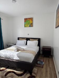 a bedroom with a large bed with white sheets at The Spring Collection in Tatu City +9 photos