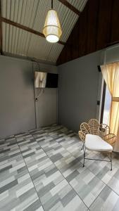 a room with a table and a chair and a light at Cabañas 2 Alajuela, San Carlos, Venecia, Marsella in Pueblo Nuevo