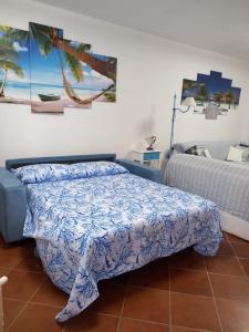 a bedroom with a bed with a blue comforter at Domus Eleonora a due passi dal mare in Golfo Aranci