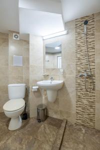 a bathroom with a toilet and a sink at Julia rooms in Sofia