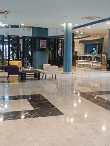 a lobby with chairs and tables in a building at Studio at El Karma Beach & Aqua Park in Hurghada +37 photos