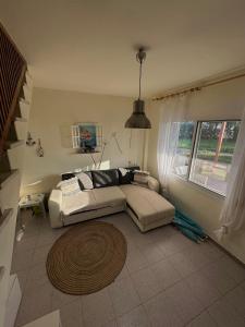 a living room with a couch and a rug at Paradise Coast House in Orfánion