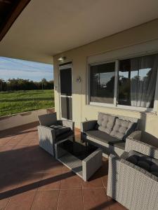 a patio with a couch and chairs and a table at Paradise Coast House in Orfánion +8 photos