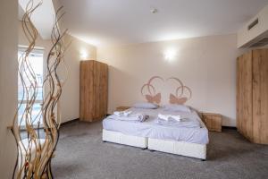 a bedroom with a bed with white sheets and wooden cabinets at Julia rooms in Sofia