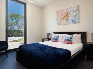 a bedroom with a large bed and a large window at Exclusive Stunning Views Pool in Road Town