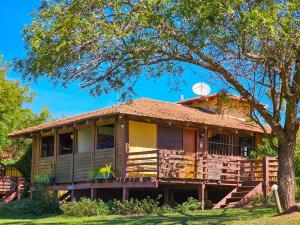 a house with a porch and a tree at Hotel Santa Esmeralda in Bonito
