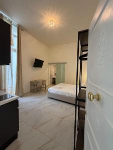 a bedroom with a bed and a desk in a room at Ippolita Palace LUXURY ROOMS in Otranto