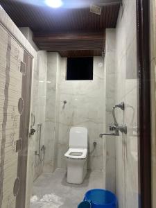 a bathroom with a toilet and a shower at Hotel yes in Jaipur