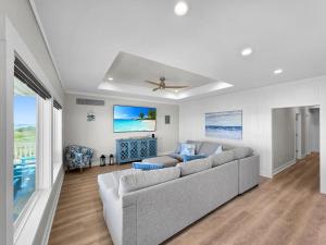 a living room with a couch and a ceiling fan at Blue Anchor home in Crystal Beach