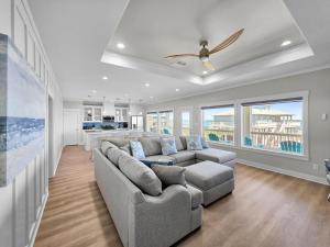a living room with a couch and a ceiling fan at Blue Anchor home in Crystal Beach +66 photos