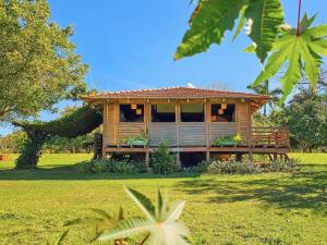 a wooden house in the middle of a field at Hotel Santa Esmeralda in Bonito