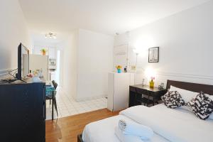 a bedroom with a bed and a desk and a kitchen at Comfort Residence in Montreal