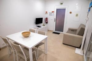 a living room with a white table and chairs at Casa Veigas in Macedo de Cavaleiros