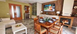 a living room with a table and a fireplace at Can Tete in Malgrat de Mar