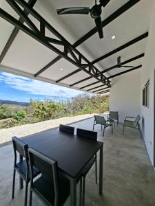 a dining room with a table and chairs on a patio at Pura Vista Lodge in Sámara