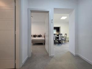 a hallway with a room with a bed and a dining room at AiZ in Kastel Stafilic