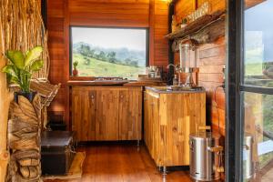 a kitchen with a sink and a window in a cabin at Mandrake Cabaña Nutria in Urrao +24 photos