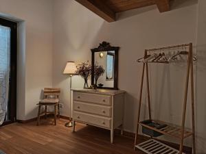 a dressing room with a dresser and a mirror at casa del corso 27 in Sirolo