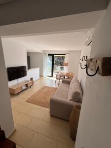 a living room with a couch and a table at Apartamentos QEli in Son Carrio