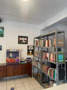 a room with a book shelf filled with books at Yek Hostels in Santa Ana