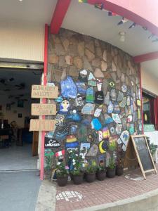 a store front with a wall covered in stickers at Yek Hostels in Santa Ana