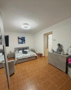 a bedroom with a bed and a child sitting on a bed frame at Alloggio DON ESTEBAN in Santa Maria della Versa +40 photos