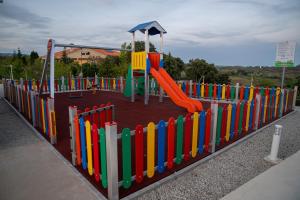 a colorful playground with a slide in a park at Casa Refúgio da Natureza in Macedo de Cavaleiros