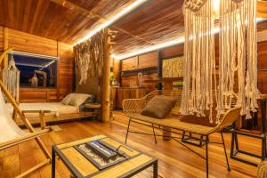 a living room with a couch and a table at Mandrake Cabaña Nutria in Urrao