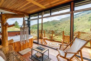 a living room with a view of a mountain at Mandrake Cabaña Nutria in Urrao