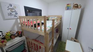 a bedroom with a bunk bed with a crib at Vila Duplex in Lipovica