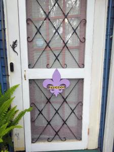a door with a pink butterfly sign on it at The Blue60 Marigny Inn in New Orleans