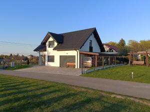 a house with a playground next to a park at Szumny Apartment 13a in Brzozówka