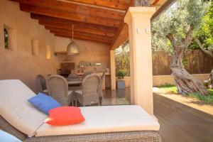 an outdoor patio with a table and chairs at Mallorca Soller Port Villa High end Balearics in Port de Soller