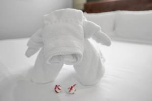 a white stuffed elephant is sitting on a bed at Medicine Park Flat's #01 in Medicine Park +21 photos