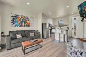 a living room with a couch and a kitchen at Medicine Park Flat's #01 in Medicine Park