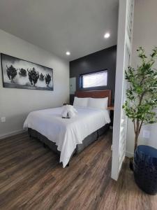 a bedroom with a large bed with white sheets at Medicine Park Flat's #01 in Medicine Park