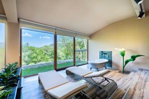 a room with chairs and a large window at Oria Retreat in Danilovgrad