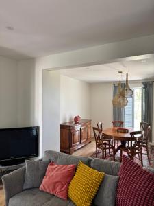 a living room with a couch and a table at Villa du Parc de Scey in Dole