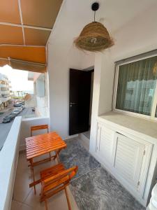 a table and two chairs in a room with a window at Cozy Beachfront 2BR in Rabat - Central & Secure in Rabat