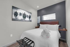 a bedroom with a bed with a stuffed animal on it at Medicine Park Flat's #03 in Medicine Park
