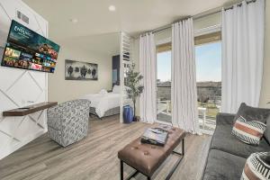 a living room with a couch and a bed at Medicine Park Flat's #04 in Medicine Park
