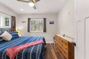 a bedroom with a bed and a window and a dresser at The Overlook at Orchard Hills in Bernard