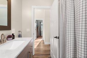 a kitchen with a sink and a shower curtain at The Overlook at Orchard Hills in Bernard +33 photos