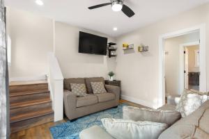 a living room with a couch and a tv on the wall at The Overlook at Orchard Hills in Bernard