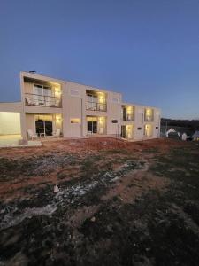a large building with a field in front of it at Medicine Park Flat's #06 in Medicine Park