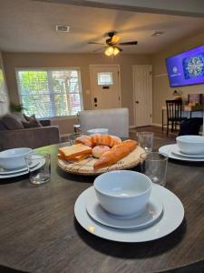 a table with a plate of bread and bowls on it at Brand new everything! Adjustable beds! Best House in Lawton