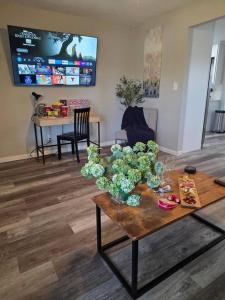 a living room with a table with flowers on it at Brand new everything! Adjustable beds! Best House in Lawton